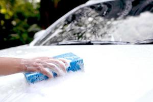 This man is washing the car and cleaning the car. photo