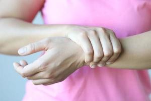 Women's pink shirt with arm pain.Health care and medical concept. photo