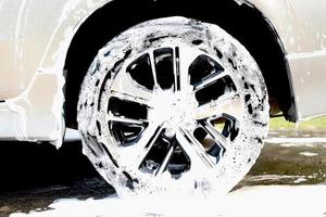 This man is washing the car and cleaning the car. photo