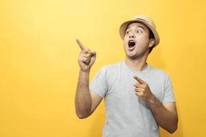 A handsome man in a good mood standing in the yellow background photo