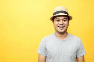 A handsome man in a good mood standing in the yellow background photo