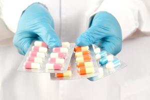 The pharmacist or doctor holds the antibiotic capsules photo