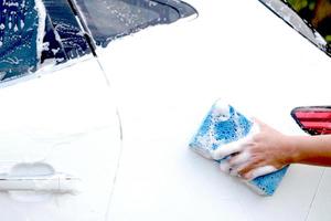 This man is washing the car and cleaning the car. photo