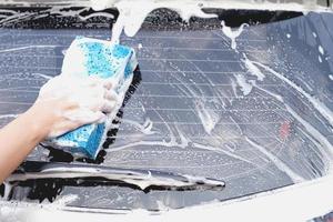 This man is washing the car and cleaning the car. photo