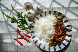 Stir-fried basil with minced pork is a popular dish because it's quick and easy to make.  spicy taste photo