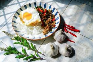 Stir Fried Basil with Minced Pork and Fried Egg is a popular dish because it's quick and easy to make.  spicy taste photo