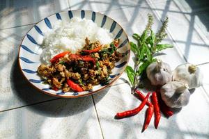 Stir-fried basil with minced pork is a popular dish because it's quick and easy to make.  spicy taste photo