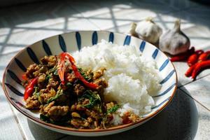 Stir-fried basil with minced pork is a popular dish because it's quick and easy to make.  spicy taste photo