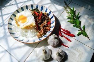 Stir Fried Basil with Minced Pork and Fried Egg is a popular dish because it's quick and easy to make.  spicy taste photo
