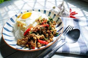Stir Fried Basil with Minced Pork and Fried Egg is a popular dish because it's quick and easy to make.  spicy taste photo