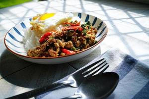 Stir Fried Basil with Minced Pork and Fried Egg is a popular dish because it's quick and easy to make.  spicy taste photo