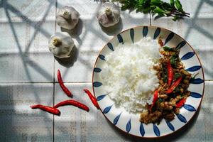 Stir-fried basil with minced pork is a popular dish because it's quick and easy to make.  spicy taste photo