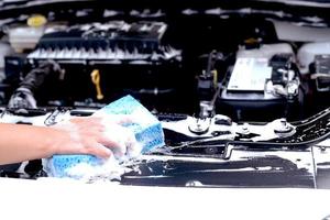 This man is washing the car and cleaning the car. photo