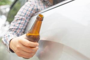 This woman eats beer while driving, emphasizes bottled beer. photo