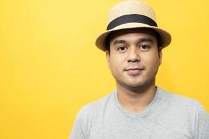 A handsome man in a good mood standing in the yellow background photo