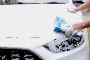 This man is washing the car and cleaning the car. photo