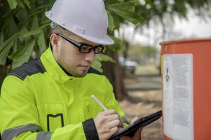 Engineers work place to keep liquid helium,preventive maintenance schedule checking,Thailand people,Technicians and engineers discuss work together. photo