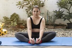 hermosa mujer gorda descansando después de yoga y ejercicio en casa. equilibrio, estilo de vida saludable, meditación, atención plena, entrenamiento, fitness, autocuidado, concepto de entrenamiento foto