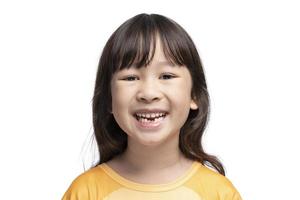 Cute Asian girl smiling showing her missing teeth in her mouth. photo