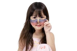 Smiling cute little asian girl wearing fashion glasses isolated on white background. photo