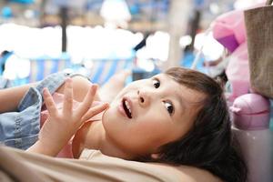 Asian smiling girl happy in denim bib tops, fun leisure concept on summer vacation photo