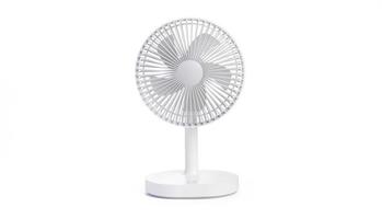 Battery powered white table fan isolated on white background with clipping path. portable battery fan photo