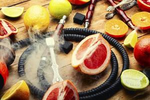 Smoking hookah with citrus fruits. photo