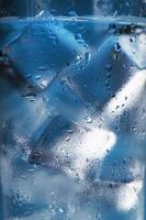 Ice cubes in a misted glass with drops of ice water close-up macro. Soft Selective Focus photo