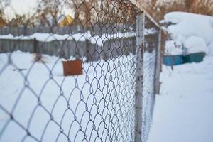 iron mesh fence in winter photo