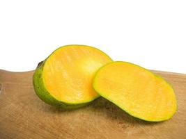 mango halved placed on wood. so that the inside is visible in orange .isolated on a white background photo