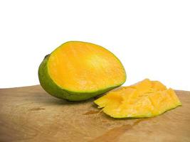 mango halved placed on wood. so that the inside is visible in orange .isolated on a white background photo