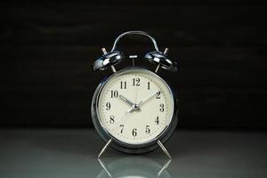 Retro alarm clock on table photo