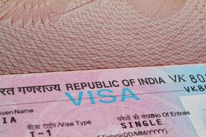 Close-up fragment of indian tourist visa in passport. Travel and tourism concept. photo