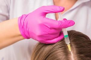 Woman receives injection in head photo