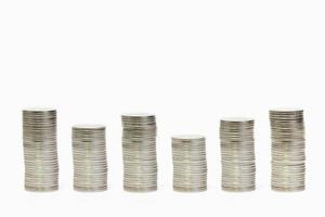 Silver coins stack arranged as graph on isolated white background, Money growing concept and sustainable investment, Business success and financial concept,  Banking and saving and economy idea photo