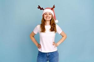 Studio portrait of young woman with long hair wearing a close hat of santa photo