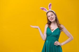 Cheerful young woman with fluffy pink bunny ears, disappointment aside photo