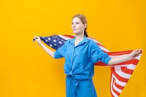 Caucasian girl. Happy young woman in blue clothes with USA flag isolated photo