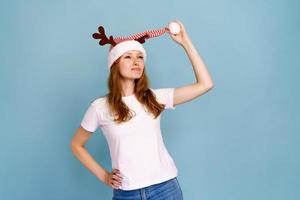 Portrait of an excited smiling caucasian girl dressed as christmas deer photo