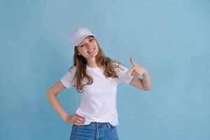 Young caucasian happy girl in delivery uniform and white cap looks confident photo