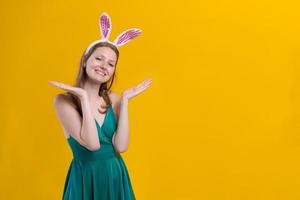 Cheerful young woman with fluffy pink bunny ears, disappointment aside photo