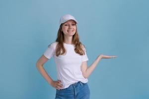 Great promo. Happy beautiful woman pointing aside at copy space with hand photo