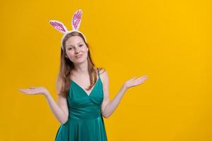 Cheerful young woman with fluffy pink bunny ears, disappointment aside photo