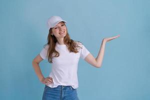 Great promo. Happy beautiful woman pointing aside at copy space with hand photo