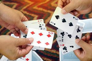 Close-up of two players showing their hand to determine the winner of the game, concept Family leisure activities or camping. Soft and selective focus. photo