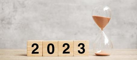 2023 text with hourglass on table. Resolution, time, plan, goal, motivation, reboot, countdown  and New Year holiday concepts photo