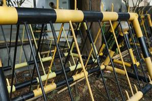 yellow black iron road divider on the side of the road photo