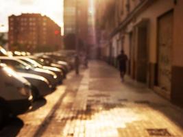 Defocused bright evening street background. City environment photo