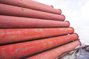 Rusted iron steel metal pipes stack an industrial field photo