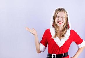 mujer feliz vistiendo ropa de santa riendo señalando con el dedo foto